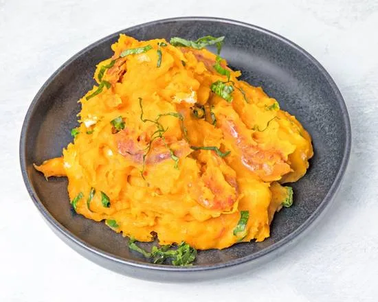 Demi's Nigferian Restaurant Yam porridge garnished in a black plate - Nigerian Comfort Food